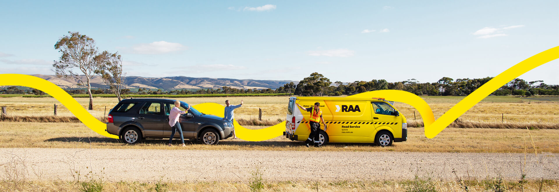 A couple waving goodbye to a Road Service patrol at the roadside