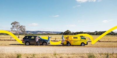 A couple waving goodbye to a Road Service patrol at the roadside
