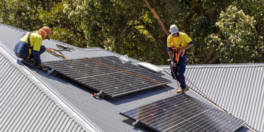 Solar panels being installed on roof